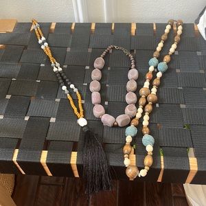 THREE necklaces with wooden beads. Various lengths and styles